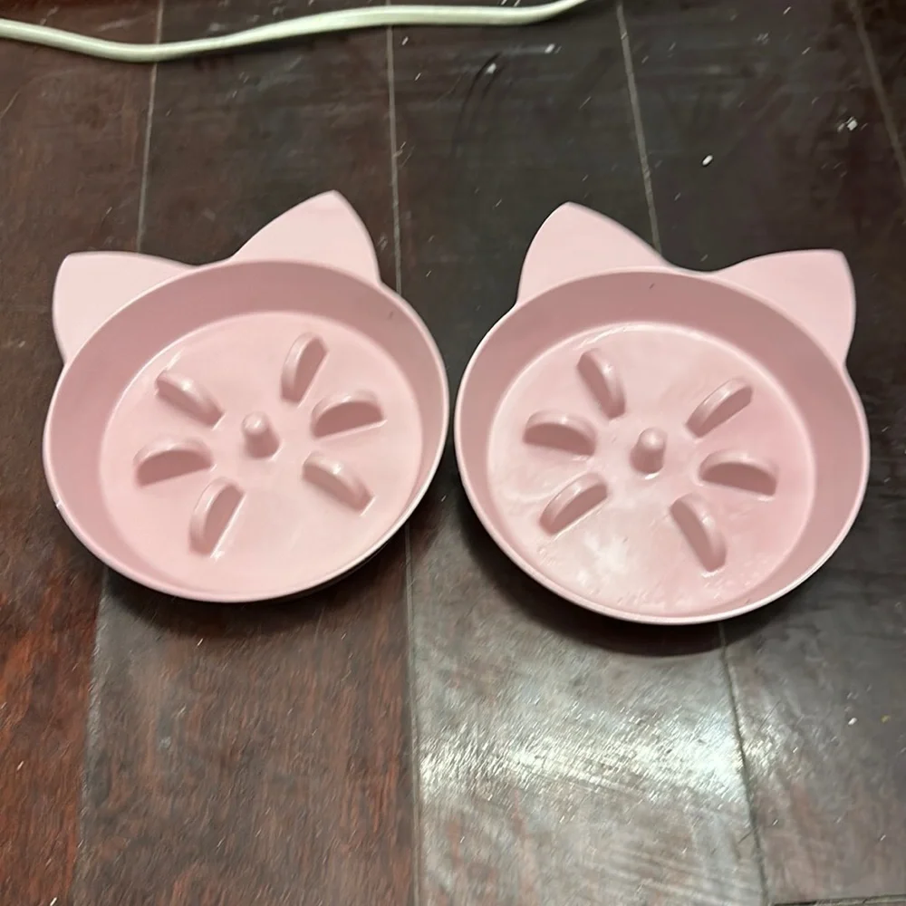 2 pink cat food bowls